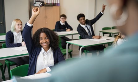 Smiling teenagers participating in classroom discussion