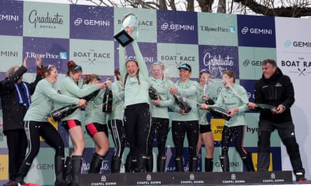 Cambridge's Caoimhe Dempsey lifts the trophy after beating Oxford in the women’s Boat Race