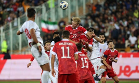 Russia’s Ruslan Litvinov heads the ball clear against Iran