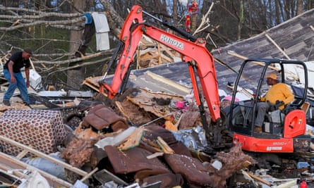 Residents look through a destroyed home in Amory, Mississippi