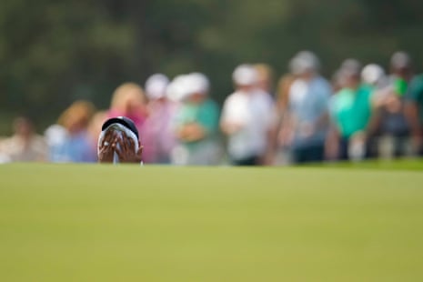 It’s hot out there as Tiger wipes his face on the 1st.